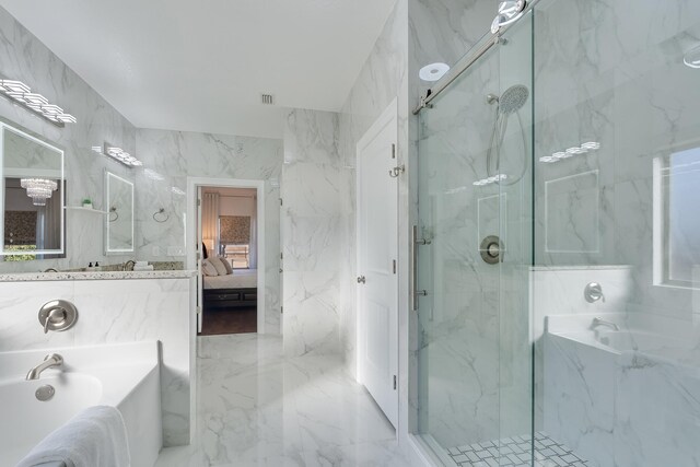 bathroom featuring tile walls and independent shower and bath