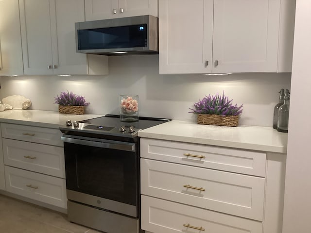 kitchen with stainless steel appliances and white cabinets