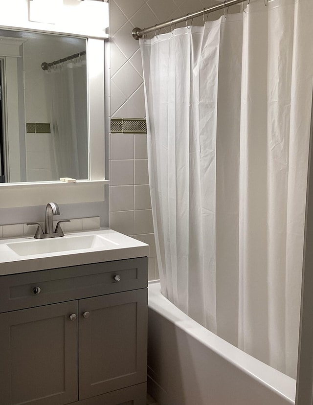 bathroom featuring vanity and shower / bath combination with curtain