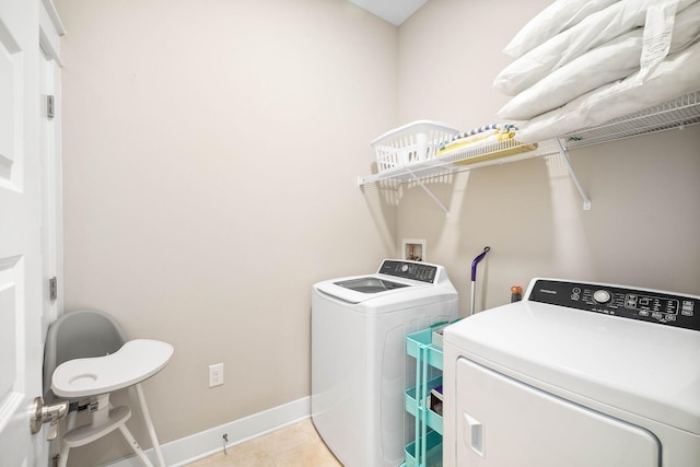 laundry room featuring washer and dryer and light tile patterned floors