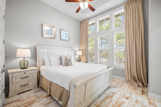 bedroom with ceiling fan and light hardwood / wood-style floors