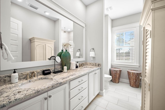 bathroom featuring toilet and vanity