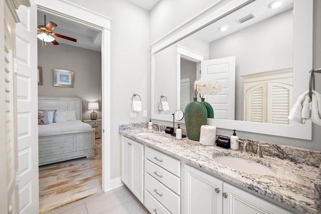 bathroom featuring ceiling fan, vanity, and tile patterned floors