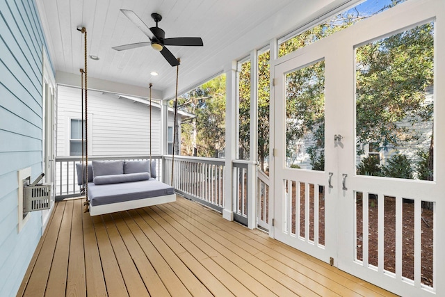 unfurnished sunroom with wood ceiling and ceiling fan