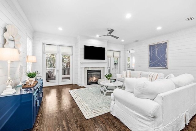 living room with ceiling fan, ornamental molding, and dark hardwood / wood-style floors