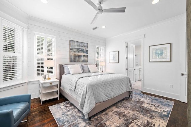 bedroom with connected bathroom, crown molding, dark hardwood / wood-style floors, and ceiling fan