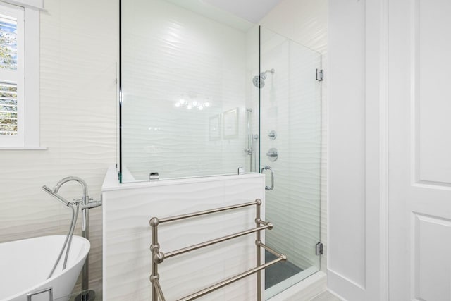 bathroom featuring separate shower and tub