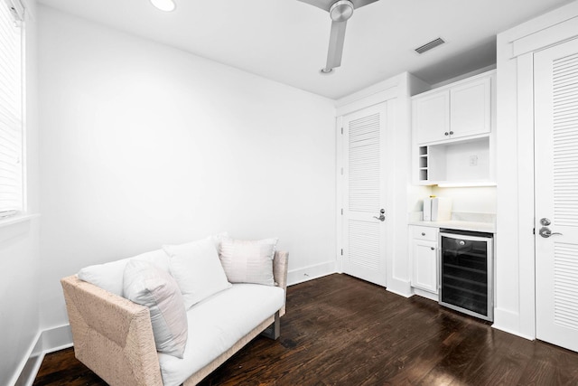 living area with wine cooler, indoor bar, dark hardwood / wood-style floors, and ceiling fan