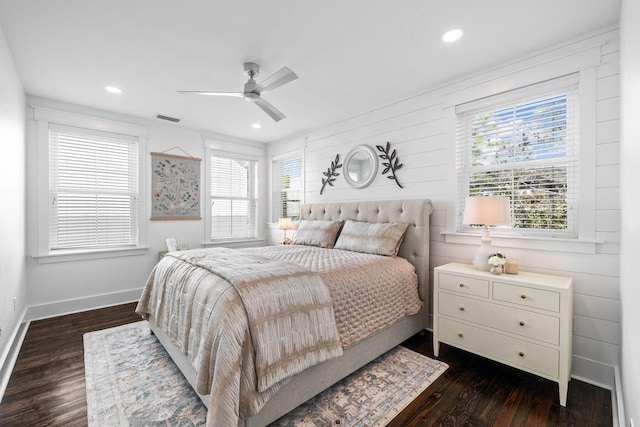 bedroom featuring dark wood-type flooring, ceiling fan, and multiple windows