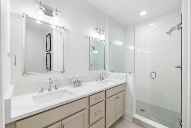 bathroom with vanity and a shower with door