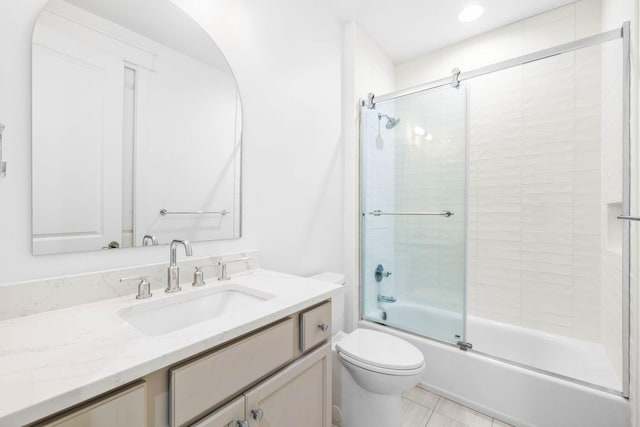 full bathroom featuring enclosed tub / shower combo, vanity, and toilet