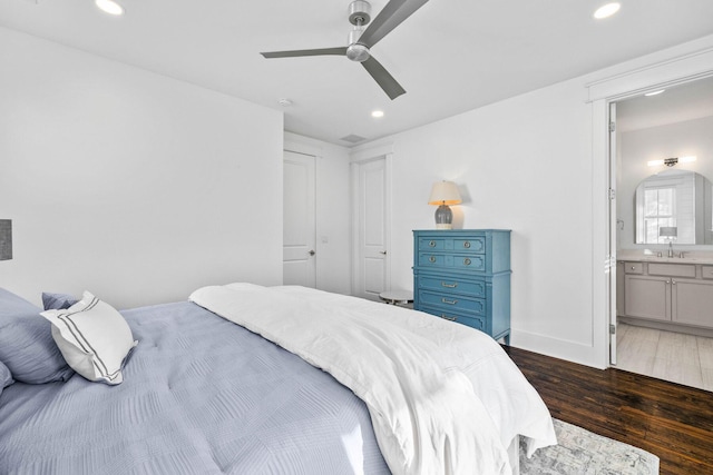 bedroom featuring ceiling fan, connected bathroom, dark hardwood / wood-style flooring, and sink