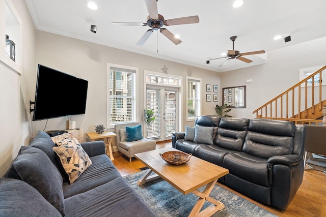 living room featuring ceiling fan, ornamental molding, and light hardwood / wood-style floors