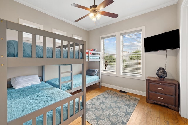 bedroom featuring ornamental molding, ceiling fan, and light hardwood / wood-style floors