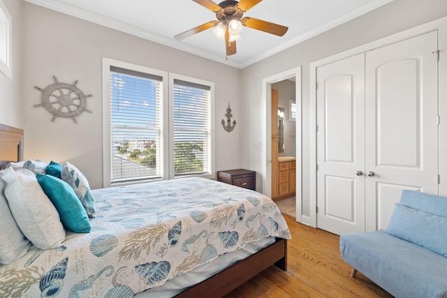 bedroom with connected bathroom, a closet, crown molding, ceiling fan, and light hardwood / wood-style flooring