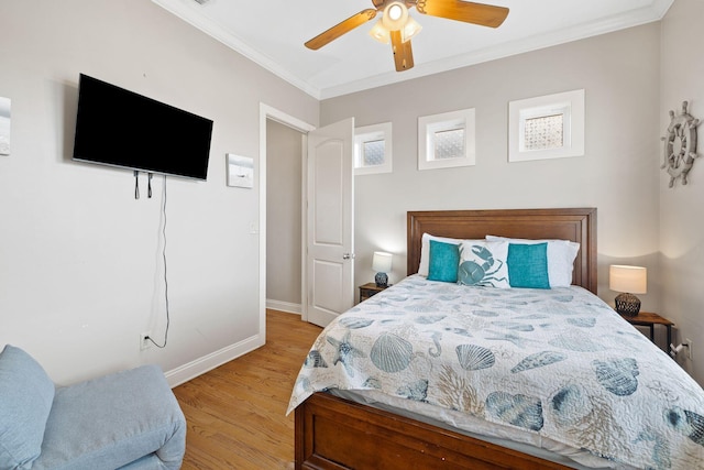 bedroom featuring ceiling fan, ornamental molding, and light hardwood / wood-style flooring