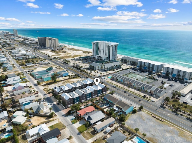 drone / aerial view featuring a beach view and a water view