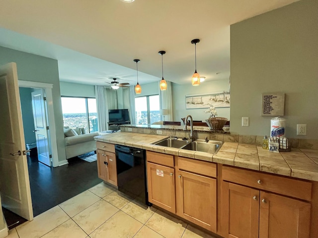 kitchen featuring sink, dishwasher, ceiling fan, light tile patterned floors, and hanging light fixtures