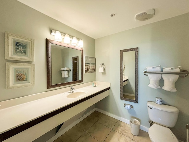 bathroom featuring sink, tile patterned floors, and toilet