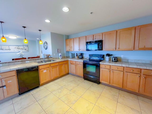 kitchen with black appliances, hanging light fixtures, tile countertops, sink, and light tile patterned flooring