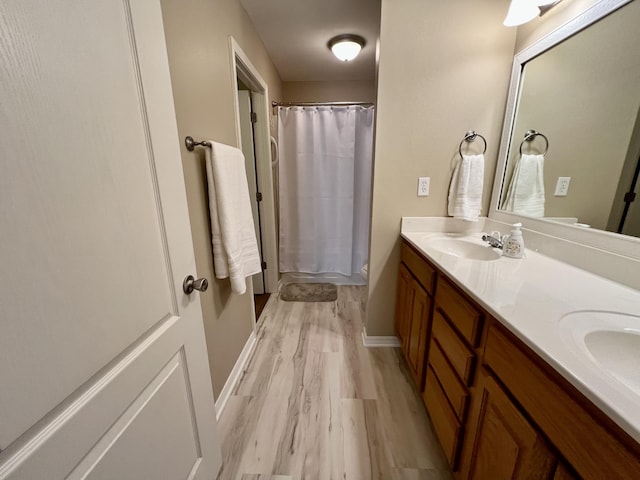 bathroom featuring vanity, a shower with shower curtain, and hardwood / wood-style flooring