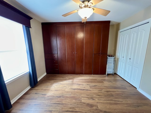 unfurnished bedroom with ceiling fan and light hardwood / wood-style flooring