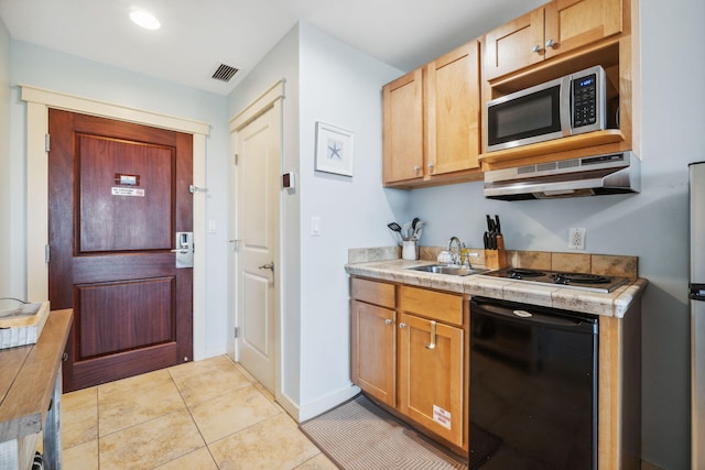 kitchen with sink, black dishwasher, cooktop, and light tile patterned floors