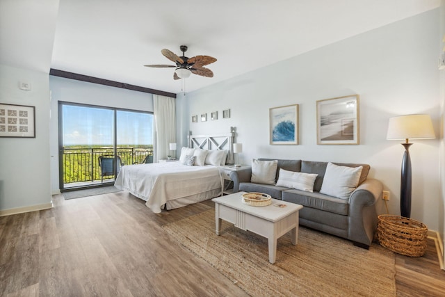 bedroom featuring ceiling fan, wood-type flooring, and access to exterior