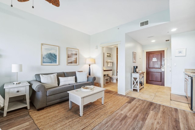 living room featuring ceiling fan and light hardwood / wood-style floors