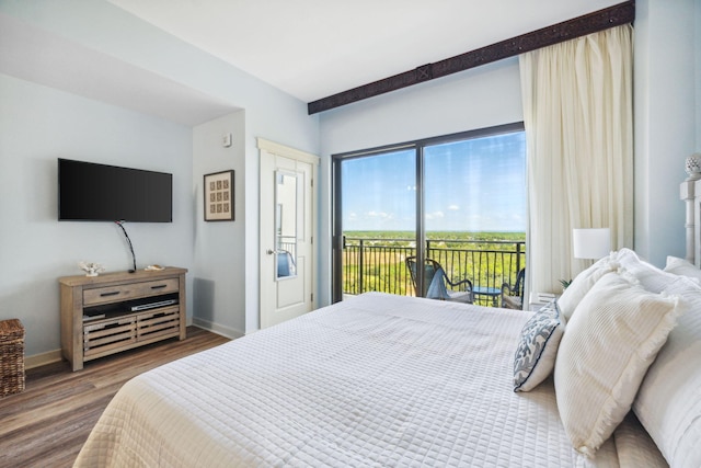 bedroom with access to outside and dark wood-type flooring