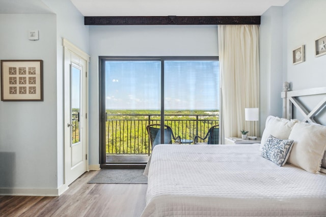 bedroom featuring hardwood / wood-style flooring and access to exterior