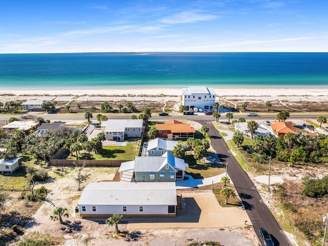 drone / aerial view with a water view and a beach view