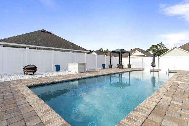 view of pool featuring an outdoor fire pit and a patio