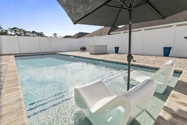 view of pool featuring a water slide and a patio