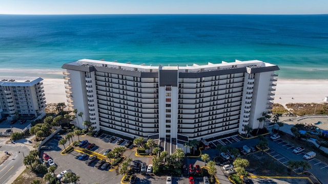 drone / aerial view with a water view and a view of the beach