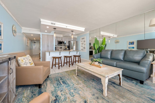 living room featuring light tile patterned floors and ornamental molding