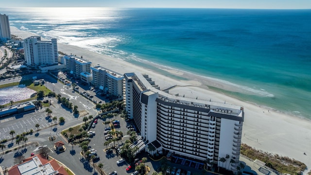 drone / aerial view featuring a water view and a beach view