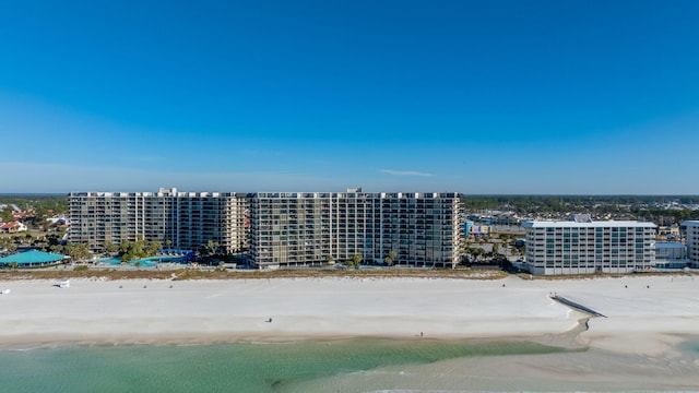 bird's eye view with a water view and a beach view