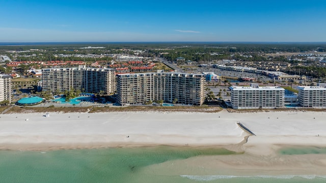 birds eye view of property featuring a water view and a beach view