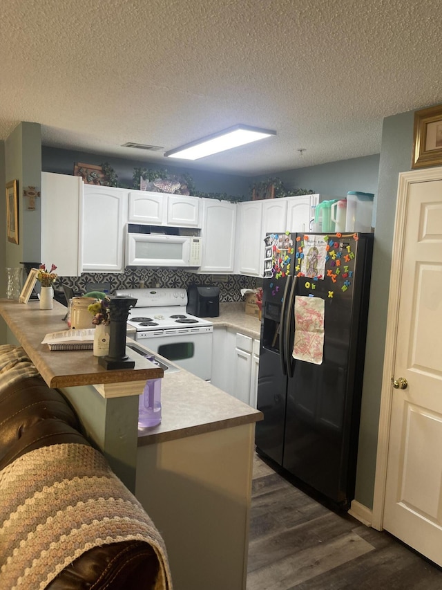 kitchen featuring white appliances, white cabinets, kitchen peninsula, and a textured ceiling