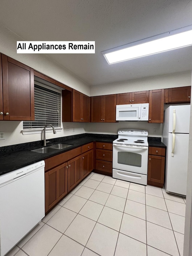 kitchen featuring white appliances, light tile patterned flooring, and sink