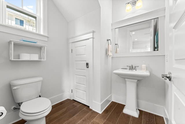 bathroom featuring toilet and lofted ceiling