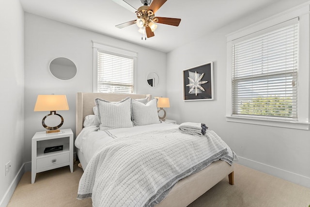 bedroom with ceiling fan and light colored carpet