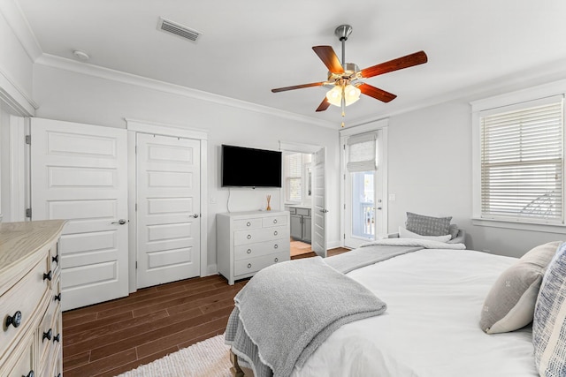 bedroom featuring ceiling fan, ornamental molding, dark hardwood / wood-style floors, and multiple windows