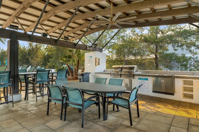 view of patio / terrace featuring an outdoor wet bar, a gazebo, and area for grilling