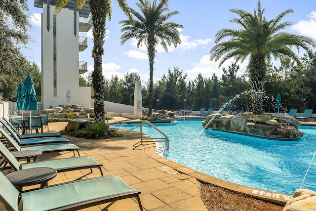 view of pool featuring pool water feature and a patio