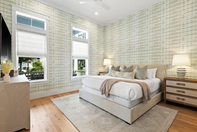 bedroom with ceiling fan, crown molding, and light hardwood / wood-style flooring