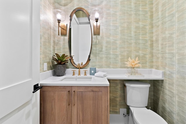 bathroom featuring toilet and vanity