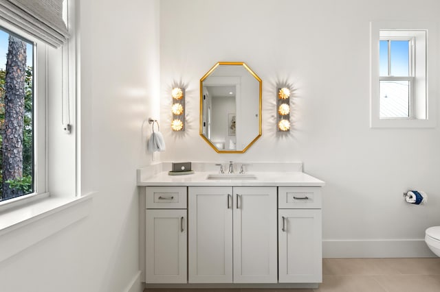 bathroom featuring vanity, tile patterned floors, and toilet