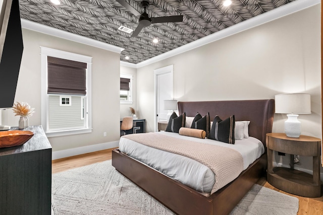 bedroom featuring ornamental molding and light hardwood / wood-style floors